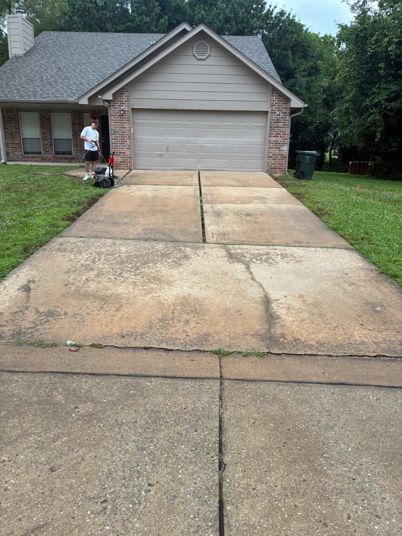 Stained driveway before pressure washing in Claremore Oklahoma